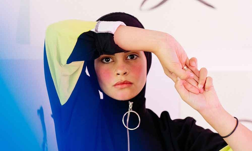 A woman dressed in athletic gear with flushed cheeks