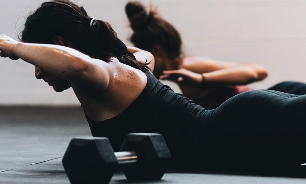 Two women doing back lifts