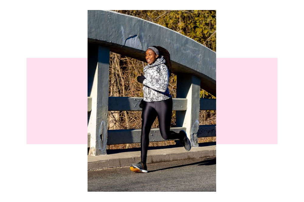 Melanie Murzeau runs across a bridge on a cool sunny afternoon.