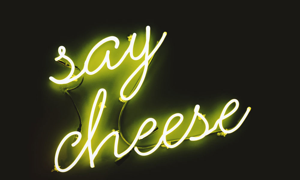 A neon sign that reads: Say cheese