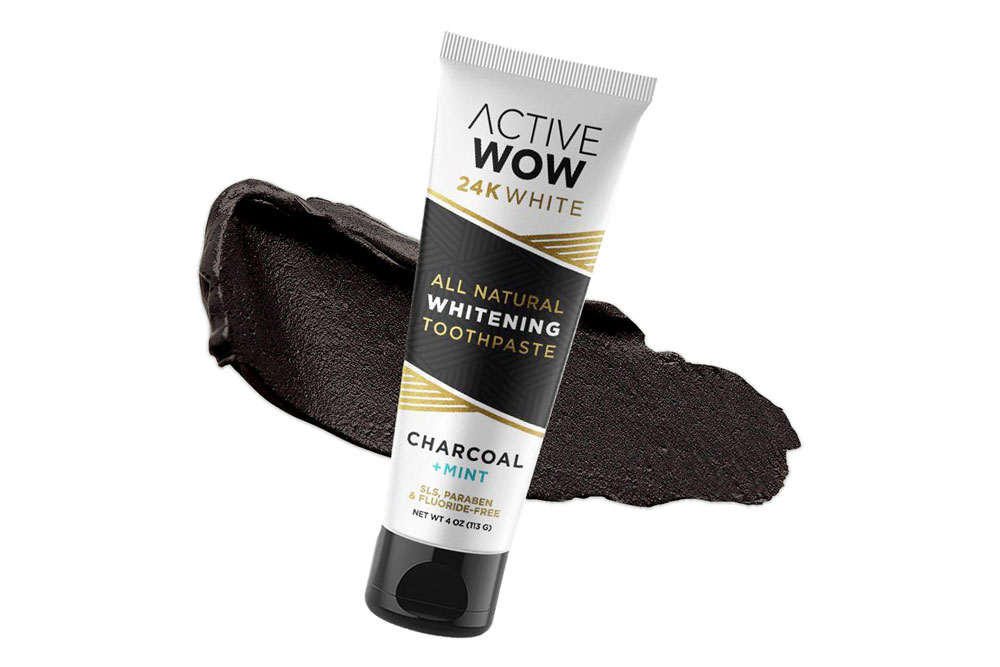 A tube of Active Wow 24K White toothpaste on a creamy swatch of toothpaste.