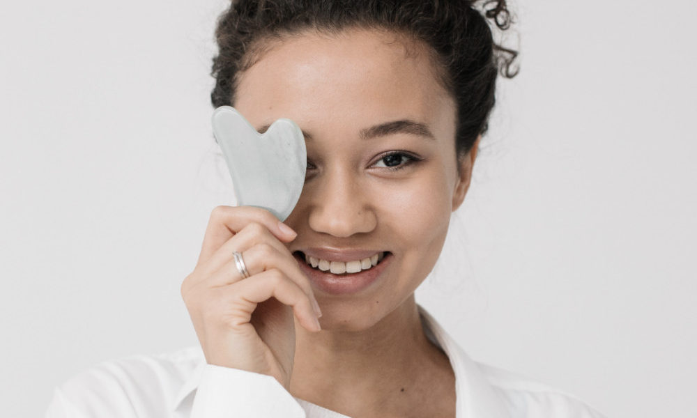 woman-holding-gua-sha-stone