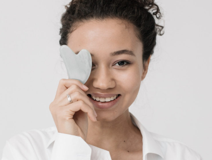 woman-holding-gua-sha-stone