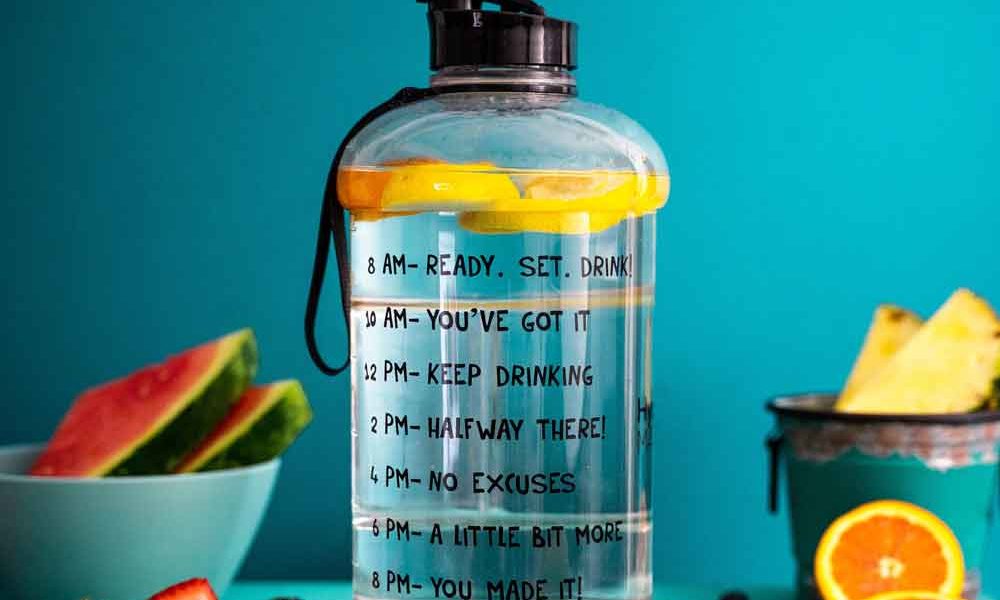 A water bottle with lemon slices and motivational phrases in place of volume measurements to encourage you to drink more: "You've got this!" "Keep drinking!" "Half way there" "A little more!" "You made it!"