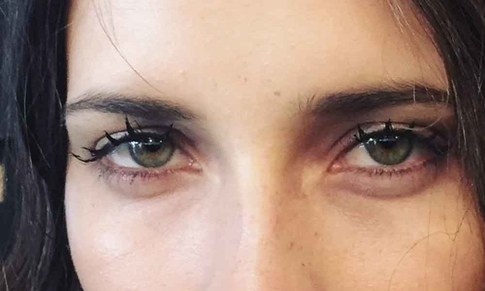 Woman with eyelashes that are grouped together to look like wet, doll-like lashes