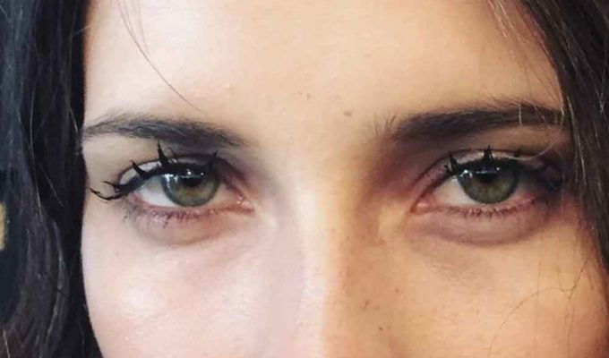 Woman with eyelashes that are grouped together to look like wet, doll-like lashes