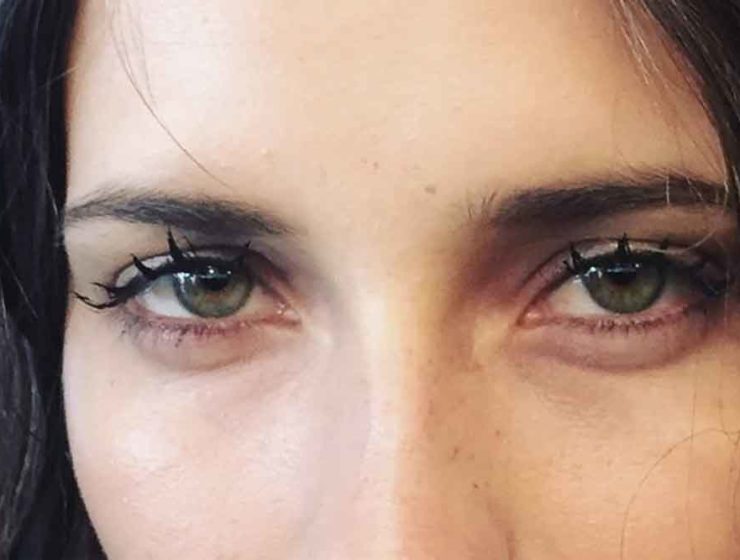 Woman with eyelashes that are grouped together to look like wet, doll-like lashes