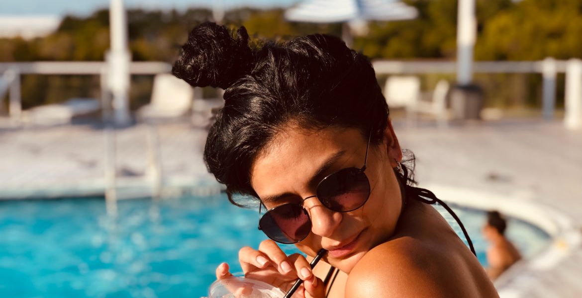 woman-on-beach-wearing-sunglasses
