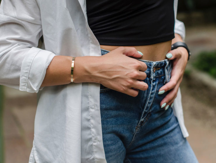 A woman holding her tummy.