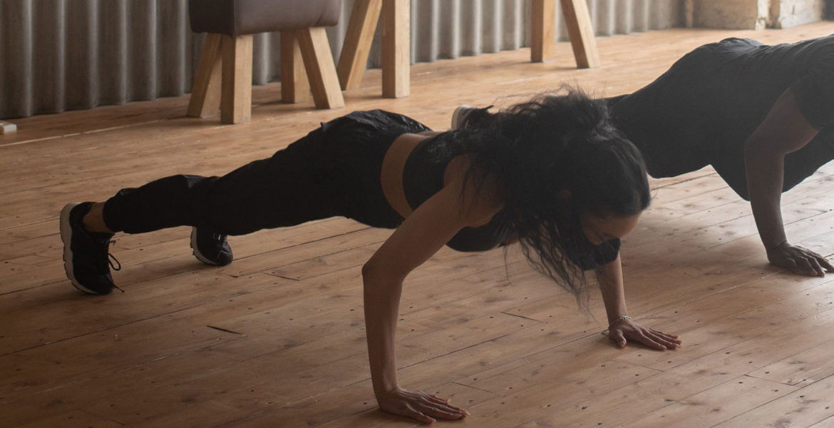 A woman doing a pushup, showing how it can put pressure on the wrists.
