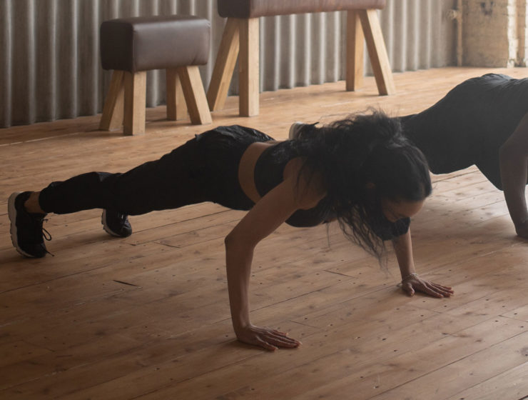 A woman doing a pushup, showing how it can put pressure on the wrists.