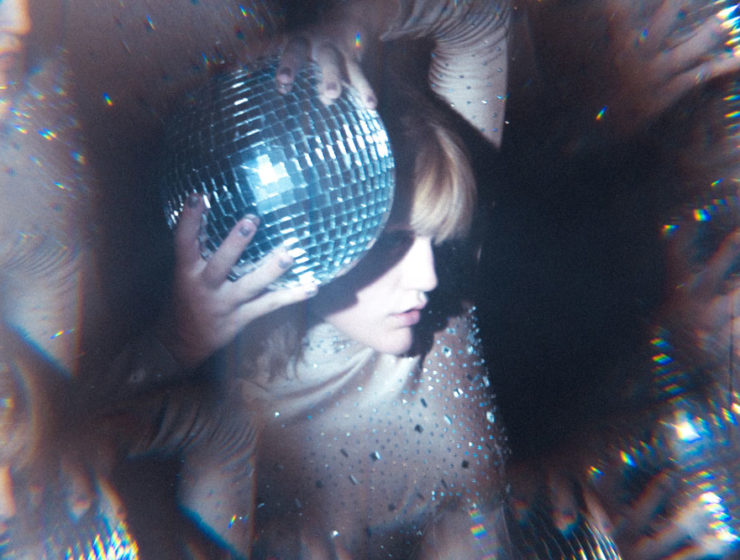 A woman holding a disco ball, which is kind the perfect compromise for a new year's story about trend predictions, right?