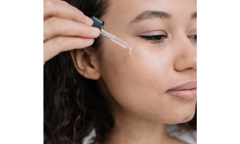 woman-using-dropper-of-oil