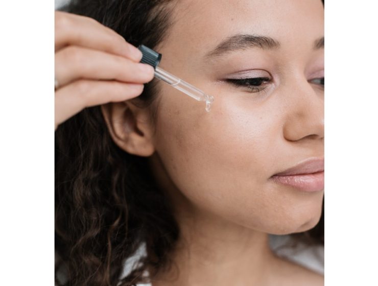 woman-using-dropper-of-oil