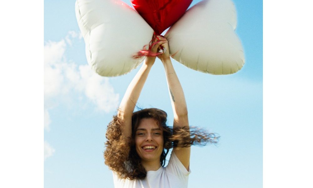 woman-holding-heart-balloons