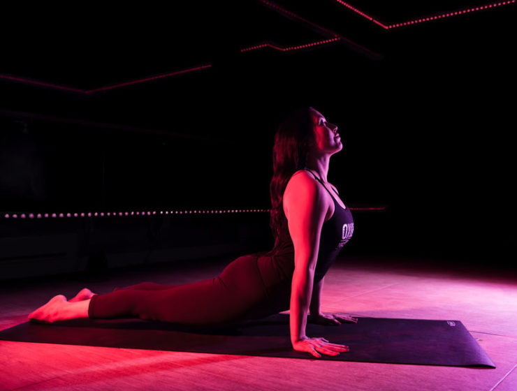 A woman doing upward dog in an infrared-heated room at Oxygen Yoga & Fitness