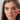 Woman getting ready to tap on a blush and lip balm