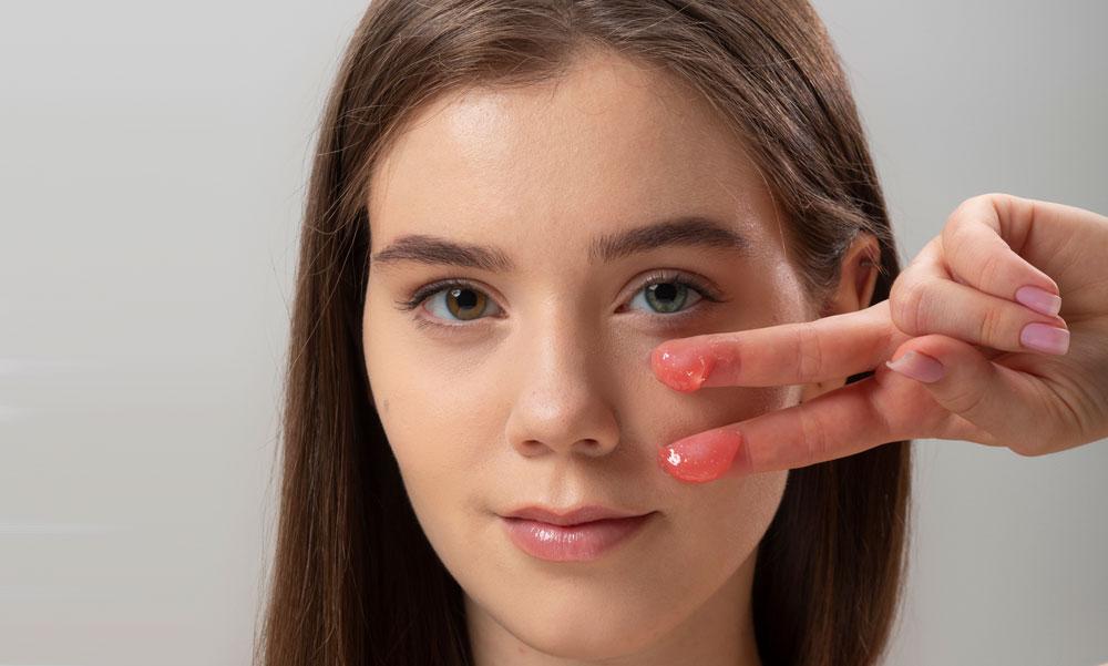 Woman getting ready to tap on a blush and lip balm