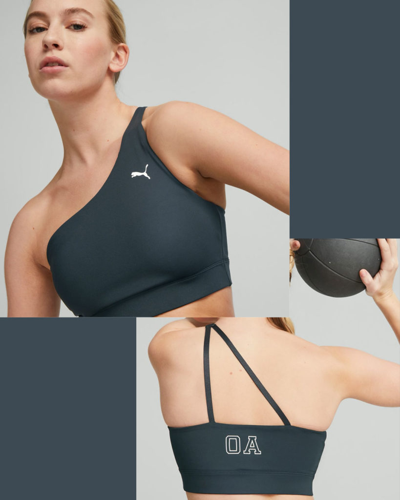 Puma’s one-shoulder sports bra has a high neck with two prong spaghetti strap back.
