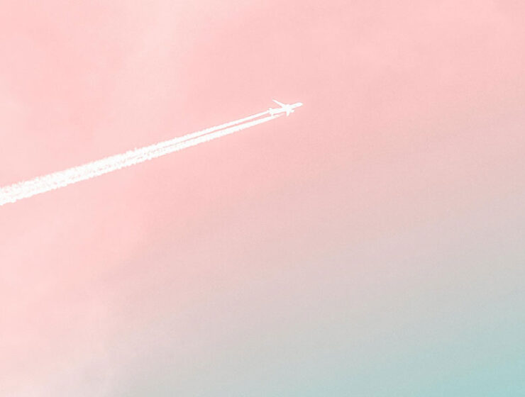 A plane in the pink sky, to symbolize a woman working in a male dominated industry in Canada