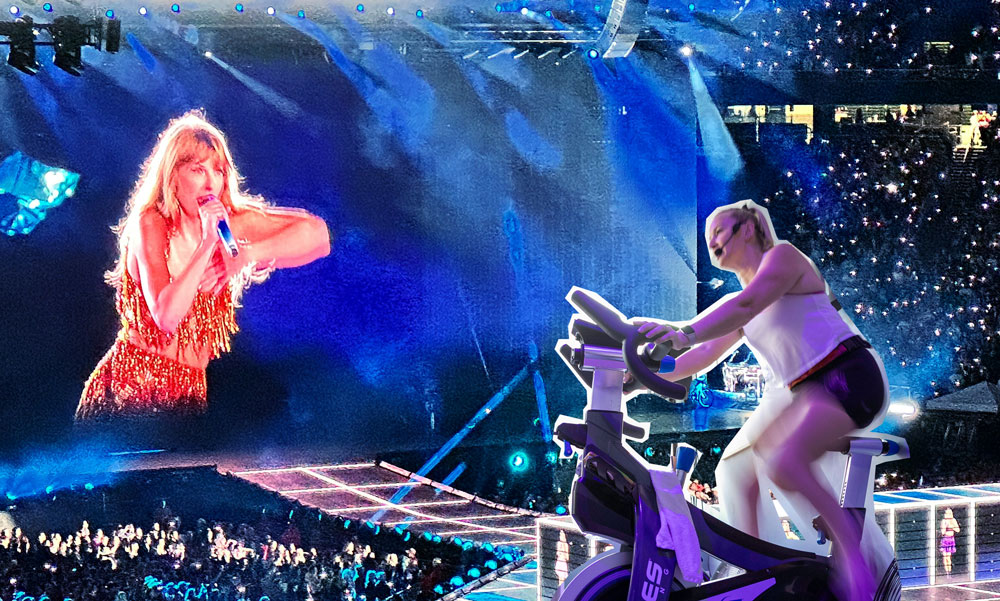 Kardia owner Heather Gardner spinning in front of Taylor Swift performing at a concert.