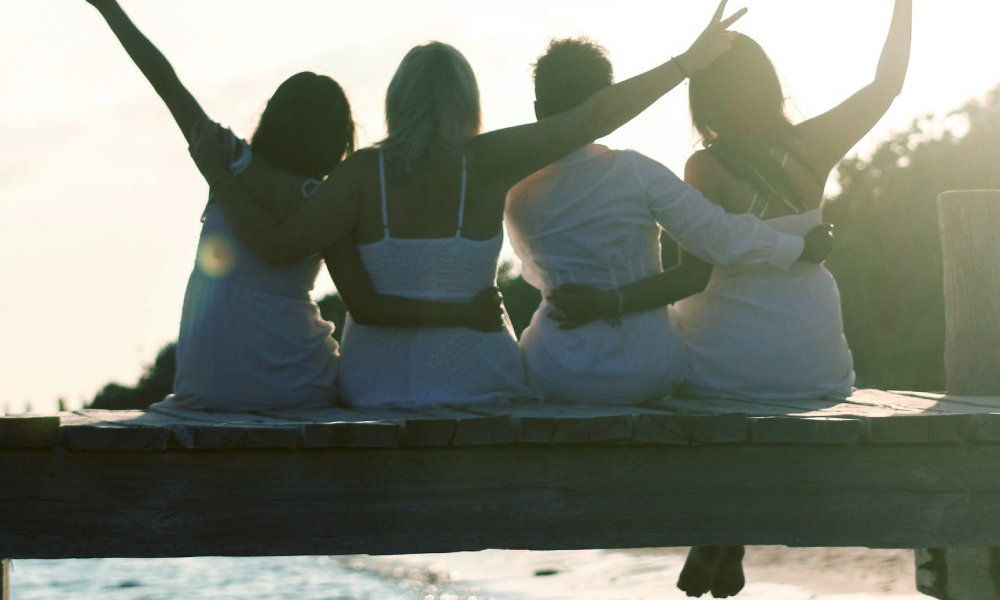 Four women on a dock, having the best long weekend ever, because they packed a fun emergency kit