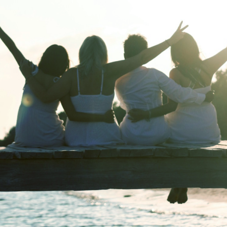 Four women on a dock, having the best long weekend ever, because they packed a fun emergency kit