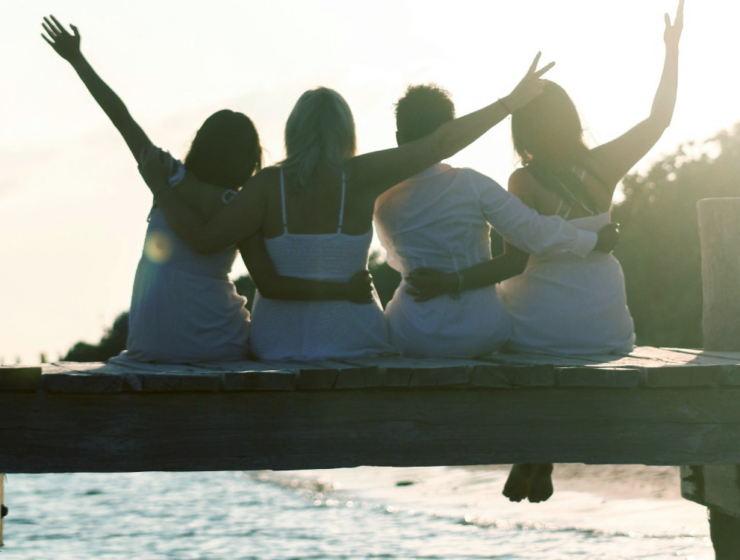 Four women on a dock, having the best long weekend ever, because they packed a fun emergency kit